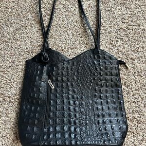 Black leather shoulder bag that converts to a backpack